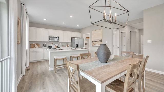 dining space with light hardwood / wood-style floors