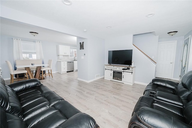 living room with plenty of natural light and light wood-type flooring