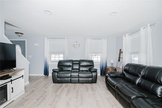 living room with light hardwood / wood-style floors and a wealth of natural light