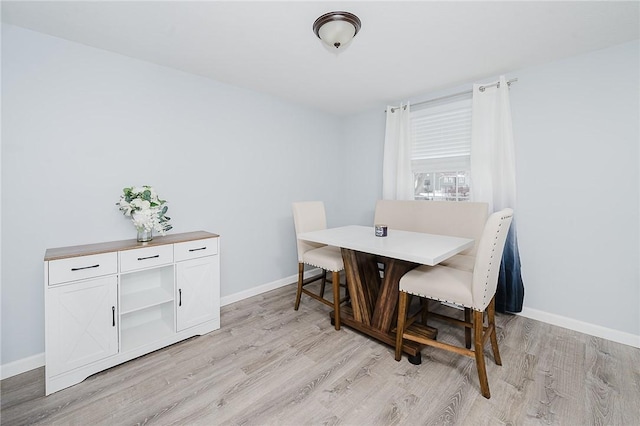 dining area with light hardwood / wood-style flooring