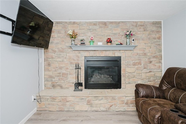 living room with a fireplace and light hardwood / wood-style floors