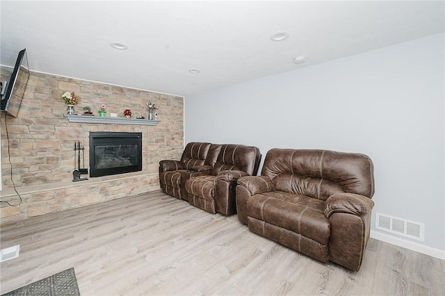 living room featuring a fireplace and light hardwood / wood-style flooring