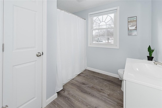 bathroom featuring hardwood / wood-style floors, vanity, and toilet