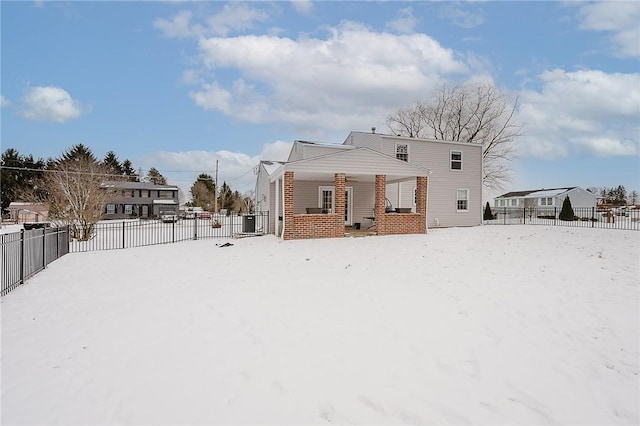 snow covered property with a porch