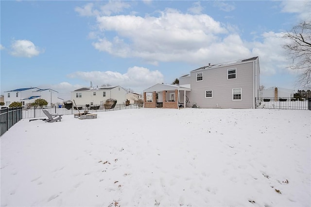 view of snow covered rear of property