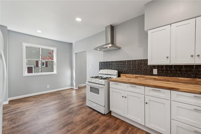 kitchen with wood counters, white cabinets, wall chimney range hood, and white gas range oven