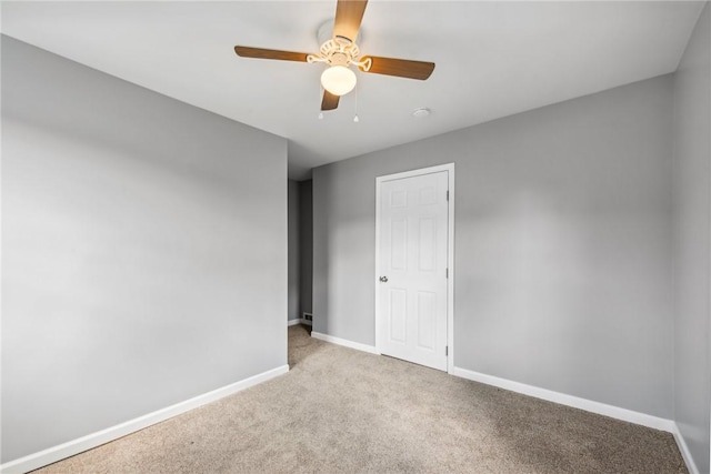 empty room with light colored carpet and ceiling fan