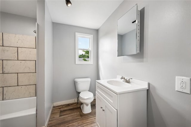 full bathroom with hardwood / wood-style floors, vanity, toilet, and tub / shower combination