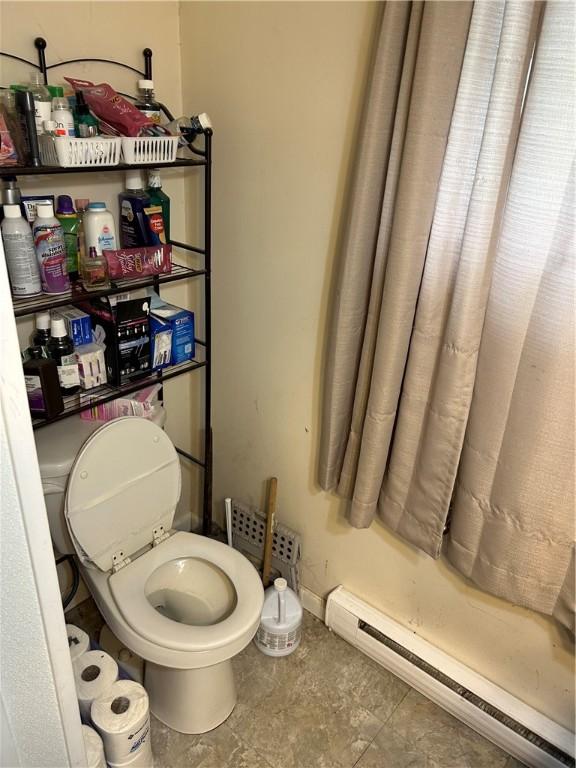 bathroom featuring toilet and baseboard heating