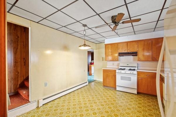 kitchen with pendant lighting, ceiling fan, white appliances, and baseboard heating