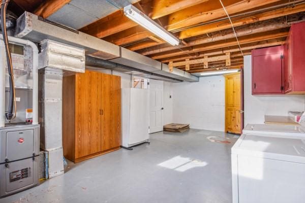 basement with white refrigerator and washer and clothes dryer