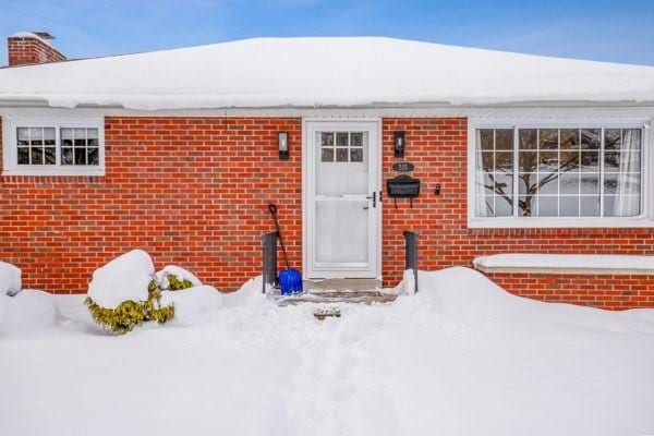 view of snow covered property entrance