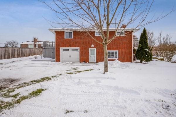 snow covered house with a garage