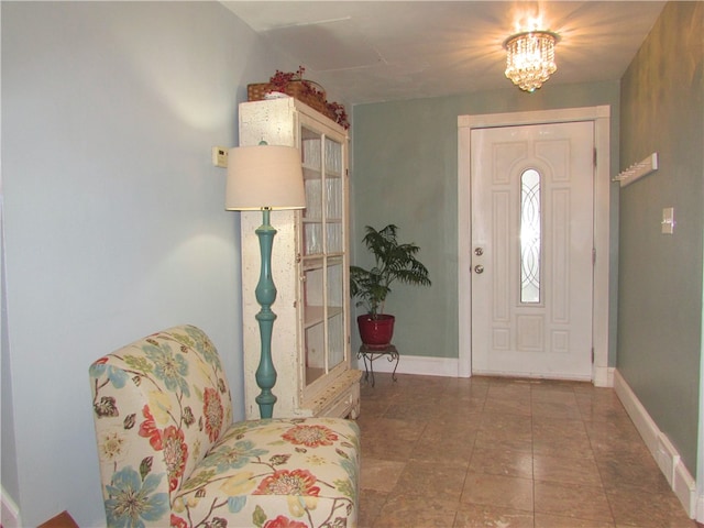 entryway with a chandelier