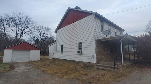 view of side of property featuring a garage and an outdoor structure