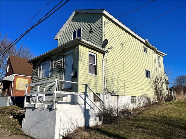 view of home's exterior with a lawn