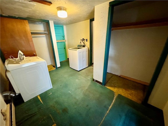 clothes washing area featuring separate washer and dryer and a textured ceiling