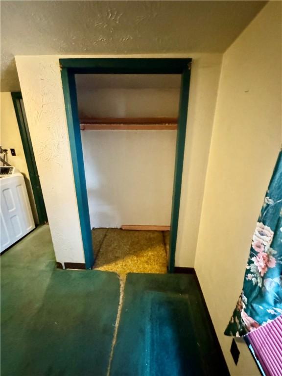 unfurnished bedroom featuring carpet flooring, washer / dryer, and a closet