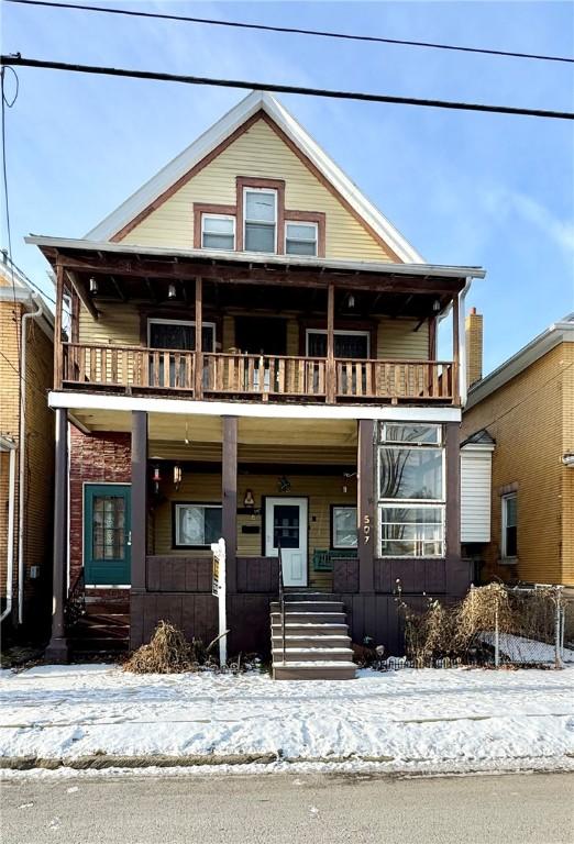 view of front of home with covered porch and a balcony