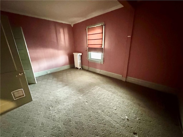 unfurnished room with built in shelves, radiator heating unit, carpet floors, and ornamental molding