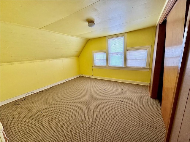 bonus room featuring carpet and vaulted ceiling