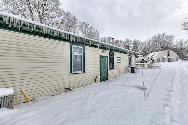 view of snow covered exterior featuring central air condition unit