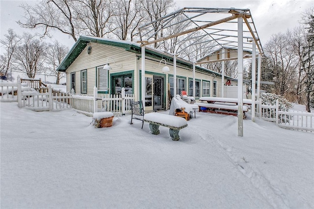 view of snow covered back of property