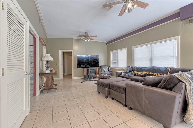 living room with ceiling fan, light tile patterned floors, vaulted ceiling, and ornamental molding