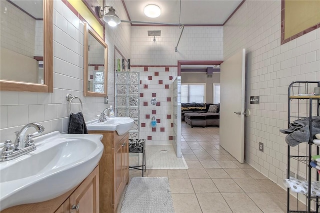 bathroom with tile patterned flooring, vanity, and tile walls