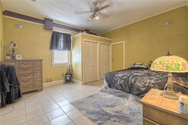 tiled bedroom with ceiling fan, a closet, crown molding, and a textured ceiling