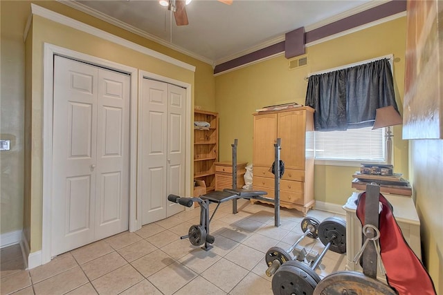 exercise area with ceiling fan, light tile patterned floors, and ornamental molding