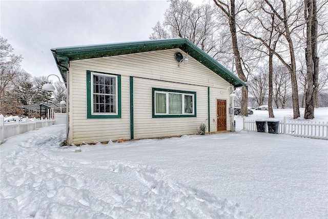 view of snow covered rear of property