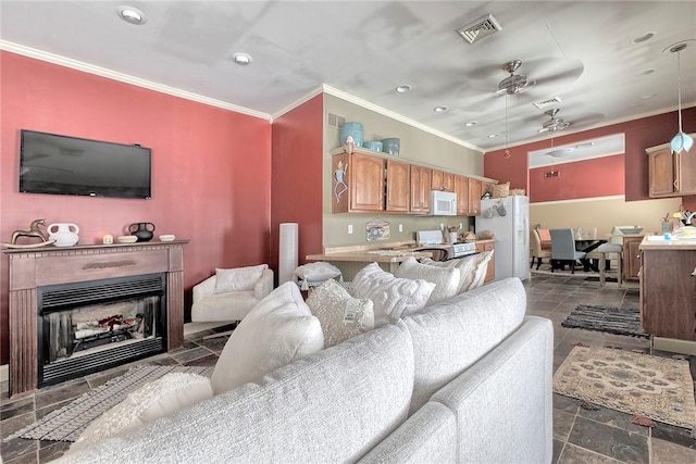 living room with ceiling fan and crown molding