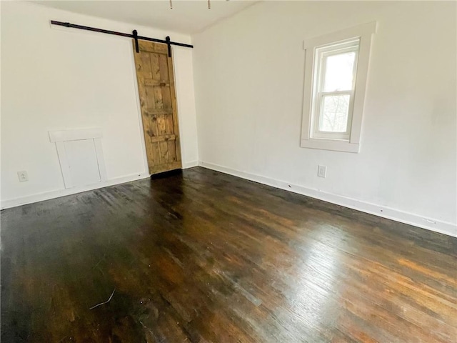 unfurnished room with a barn door