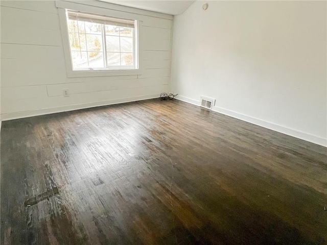 unfurnished room with dark hardwood / wood-style floors