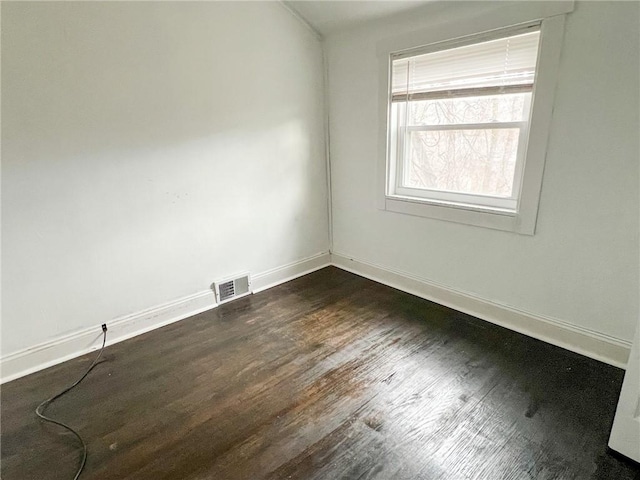 spare room featuring dark hardwood / wood-style flooring