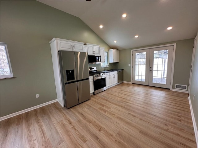 kitchen with french doors, stainless steel appliances, sink, white cabinets, and light hardwood / wood-style floors