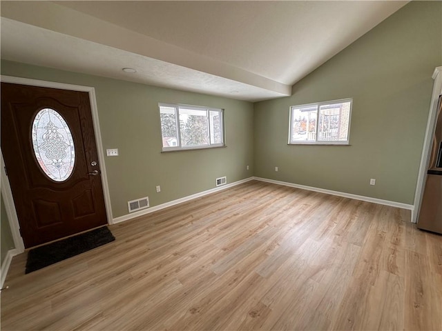 entryway featuring light hardwood / wood-style floors and lofted ceiling