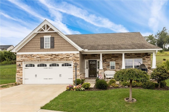 craftsman house with a front lawn and a garage