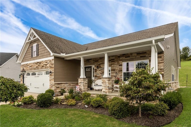 craftsman-style house featuring covered porch, a garage, and a front yard