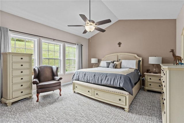 bedroom with ceiling fan, light colored carpet, and lofted ceiling