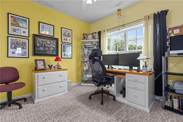 carpeted home office featuring ceiling fan