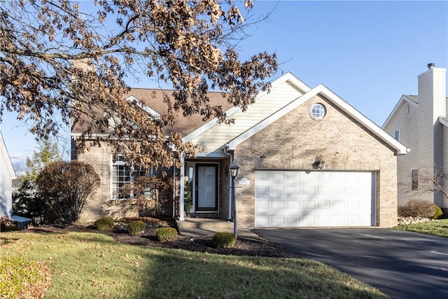 view of front of property featuring a front lawn and a garage