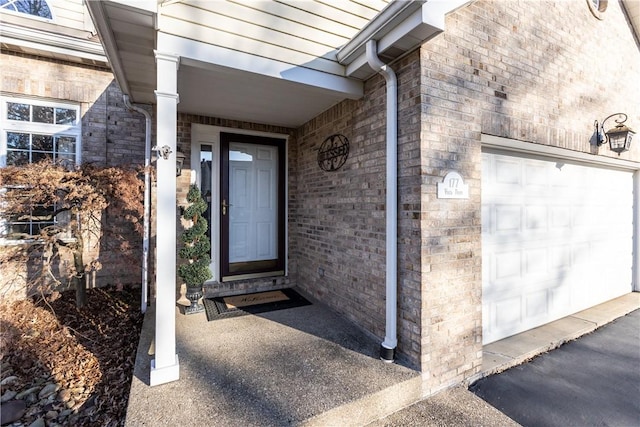 view of exterior entry featuring a garage