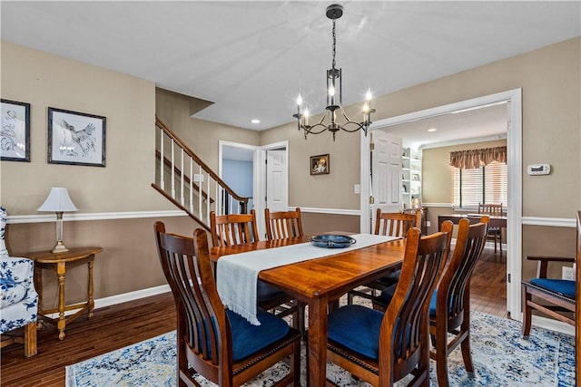 dining space with a chandelier and dark hardwood / wood-style flooring