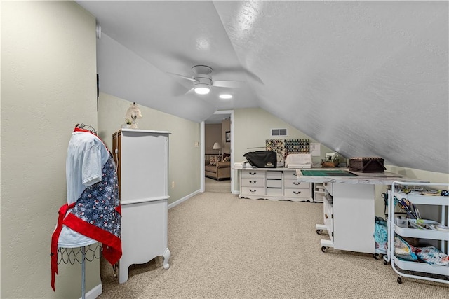 interior space featuring light carpet, a textured ceiling, ceiling fan, and lofted ceiling