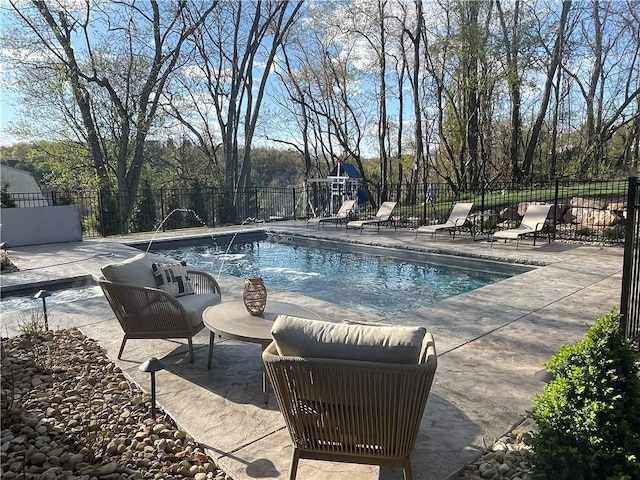 view of swimming pool featuring pool water feature and a patio