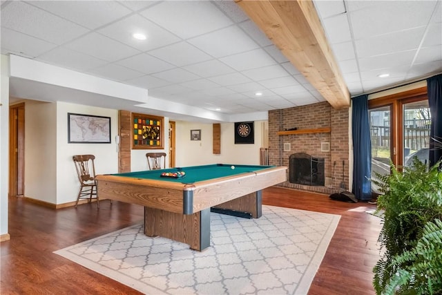 playroom featuring a paneled ceiling, a fireplace, wood-type flooring, and pool table