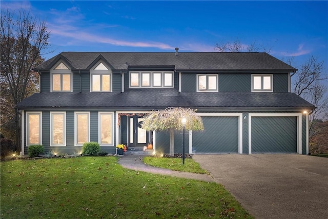 view of front facade featuring a lawn and a garage