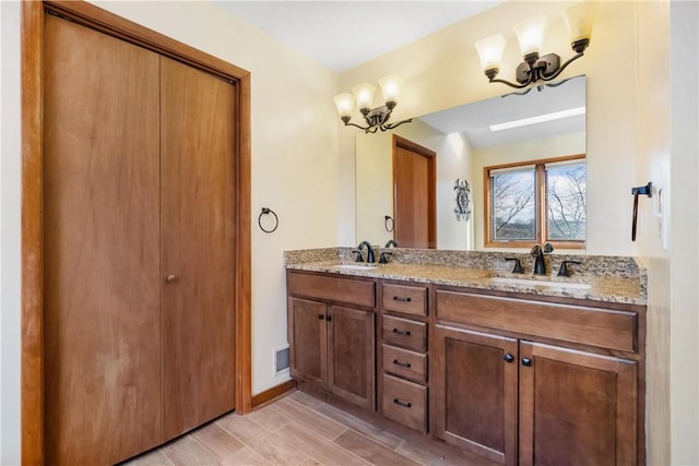 bathroom featuring vanity and a chandelier